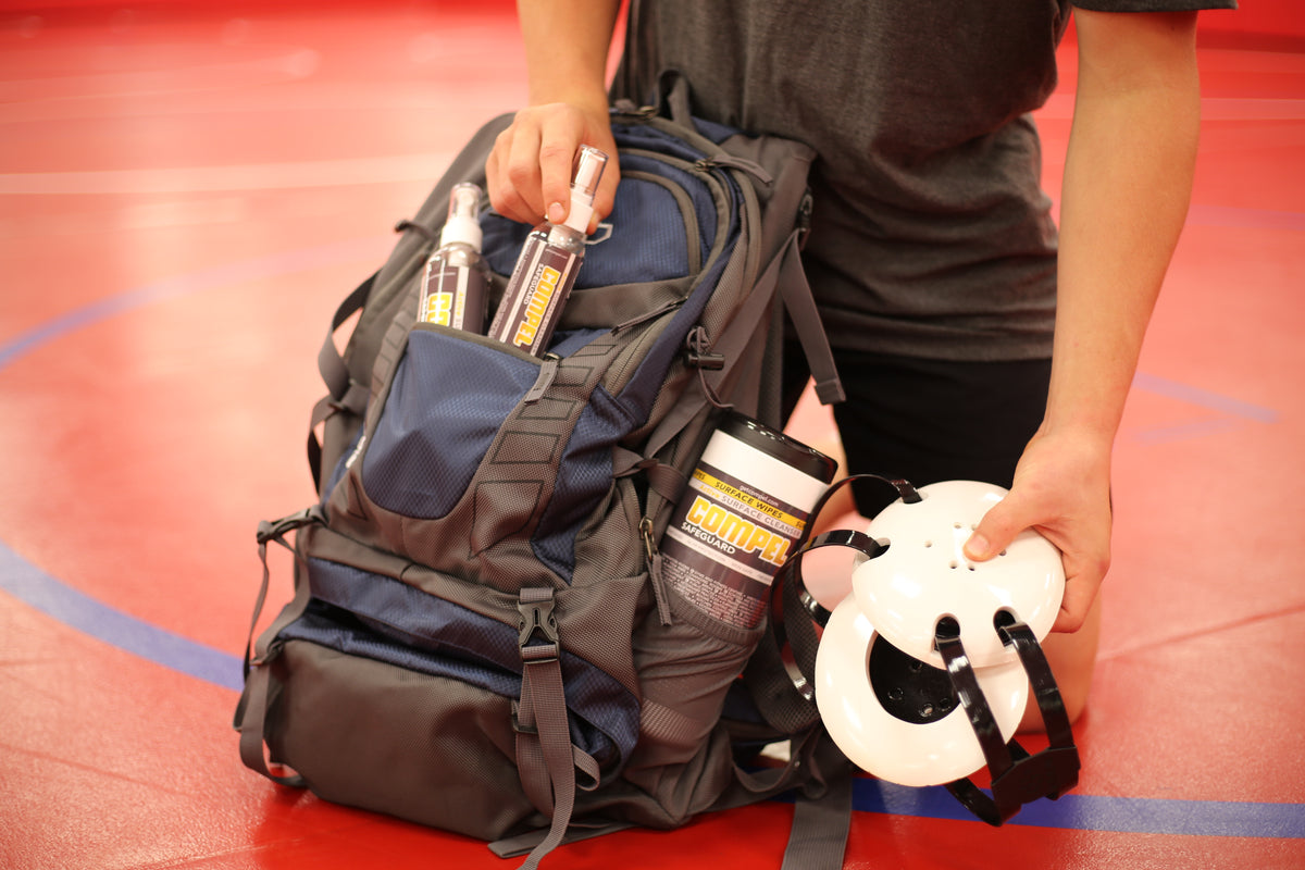 Wrestling gear bag and headgear with COMPEL SAFEGUARD surface cleanser